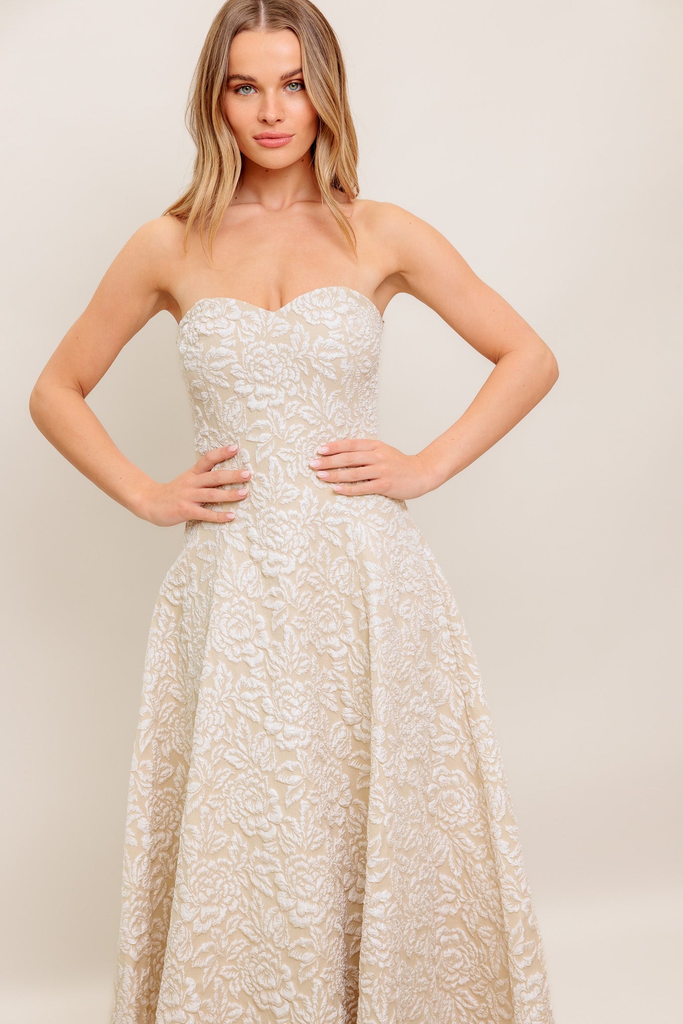 A textured woven midi dress featuring strapless sweetheart neckline, circle skirt and back zipper closure