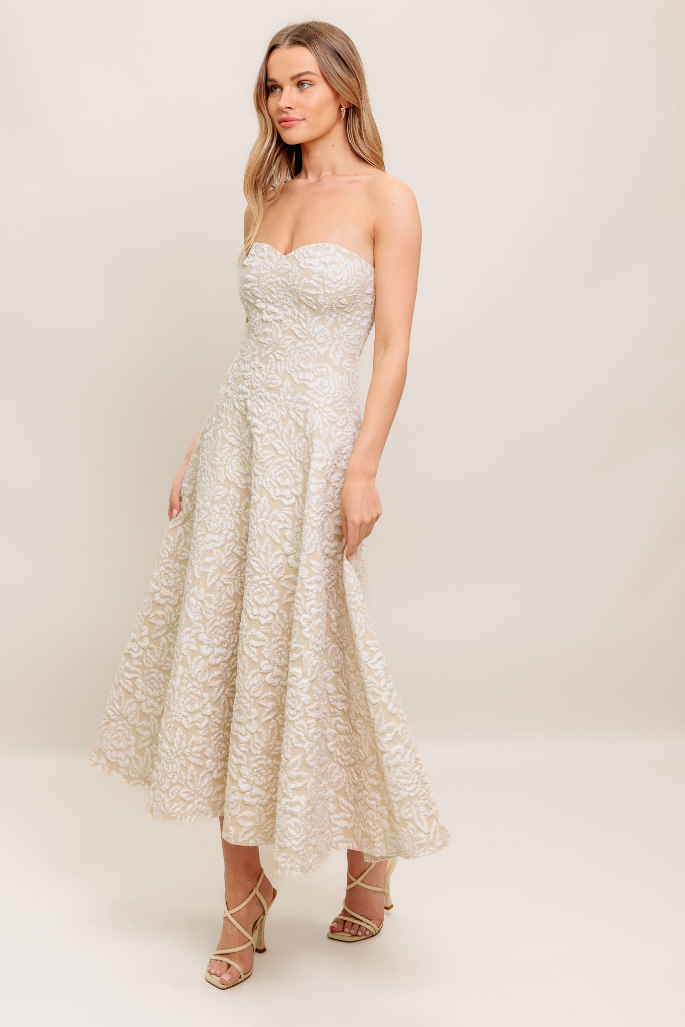 A textured woven midi dress featuring strapless sweetheart neckline, circle skirt and back zipper closure