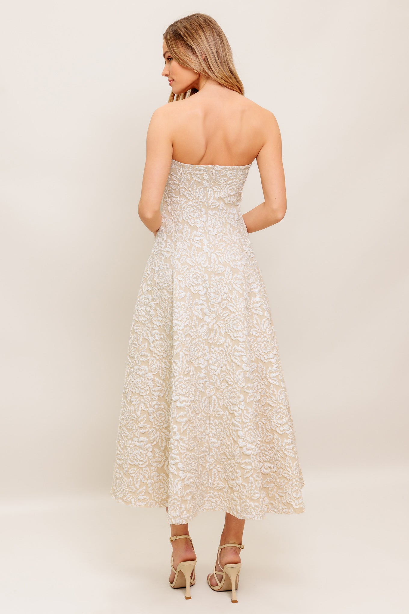 A textured woven midi dress featuring strapless sweetheart neckline, circle skirt and back zipper closure