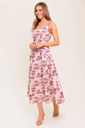 A printed woven midi dress featuring square neckline, sleeveless, circle skirt and back zipper closure.