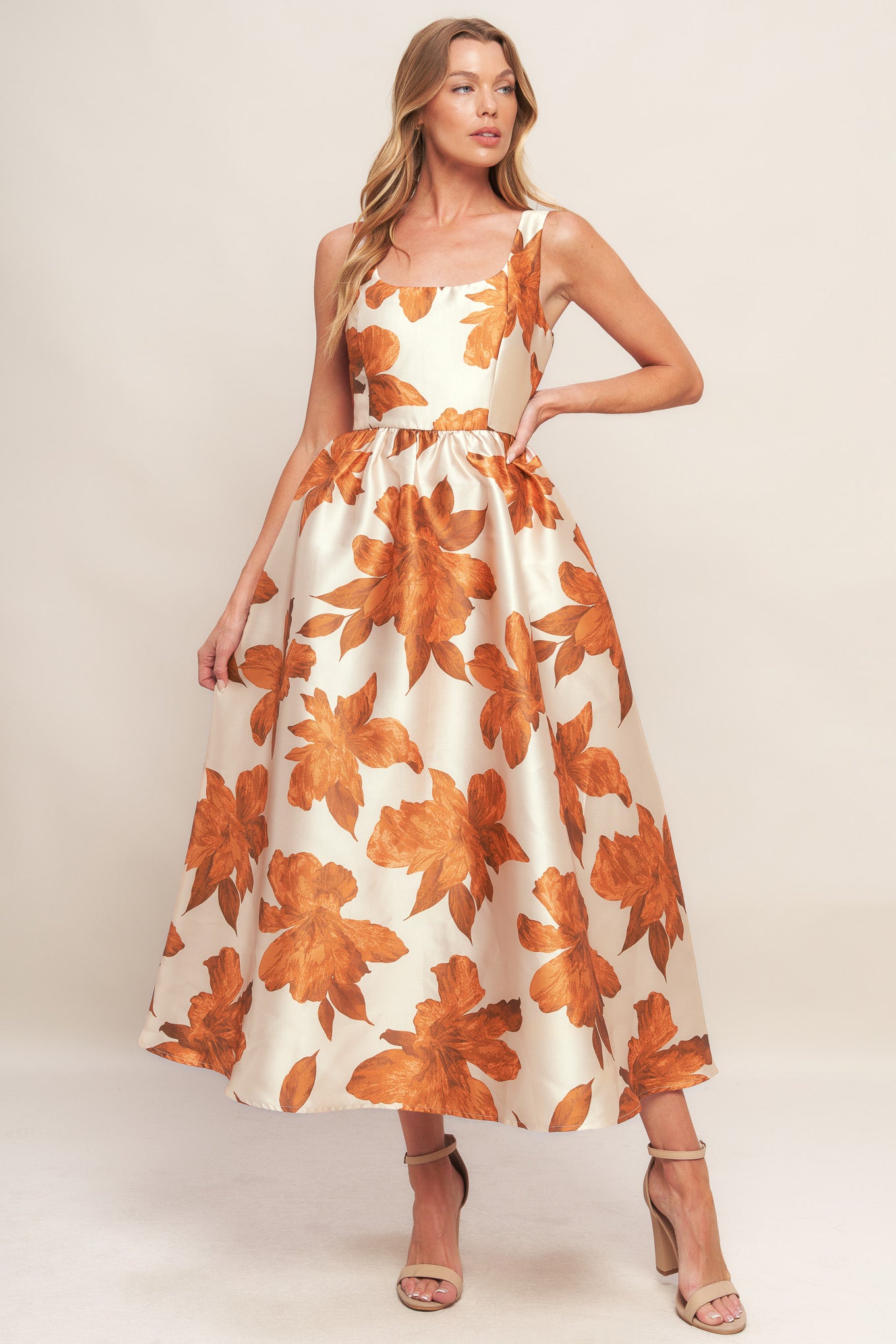 A printed woven midi dress featuring U neckline, sleeveless, full skirt and back zipper closure