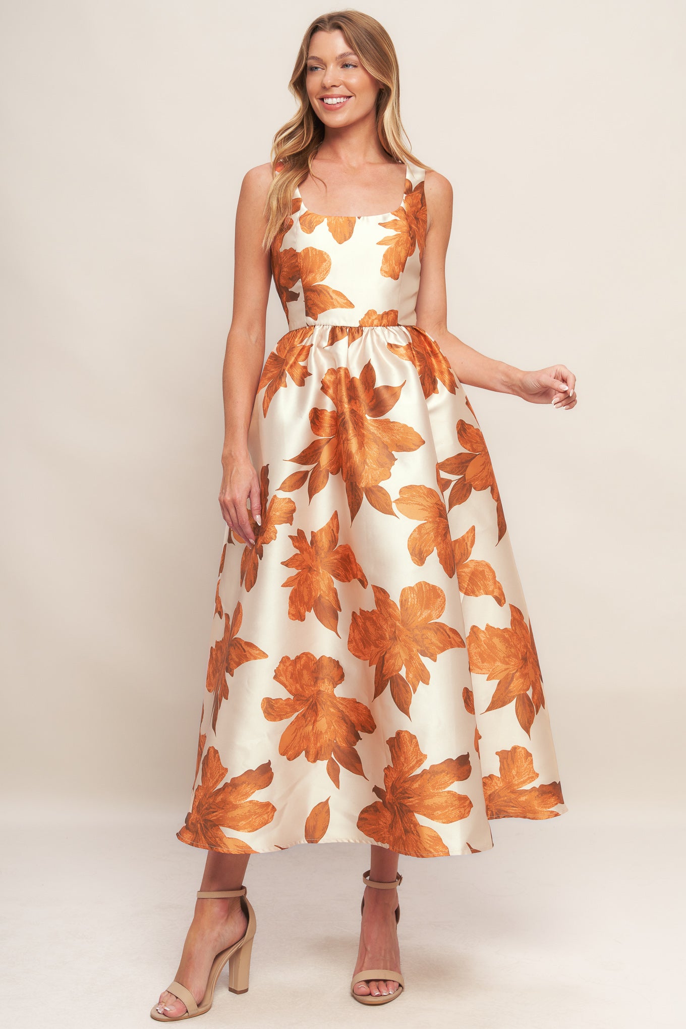 A printed woven midi dress featuring U neckline, sleeveless, full skirt and back zipper closure