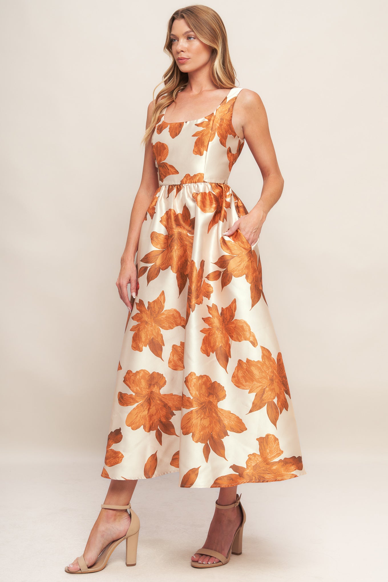 A printed woven midi dress featuring U neckline, sleeveless, full skirt and back zipper closure