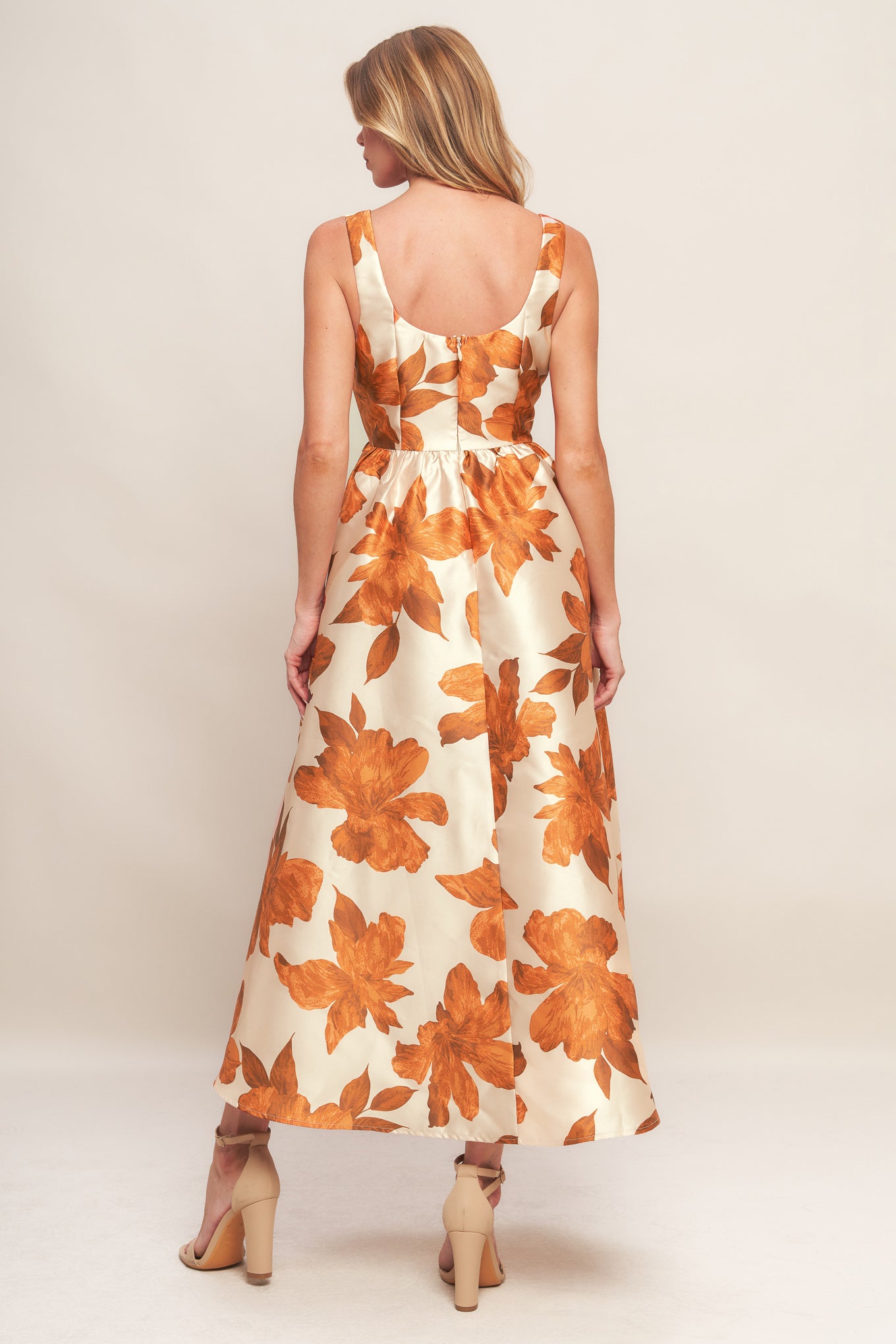 A printed woven midi dress featuring U neckline, sleeveless, full skirt and back zipper closure