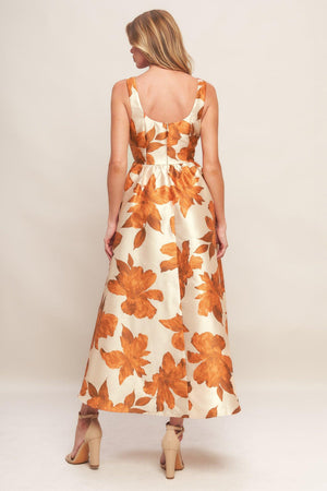 A printed woven midi dress featuring U neckline, sleeveless, full skirt and back zipper closure
