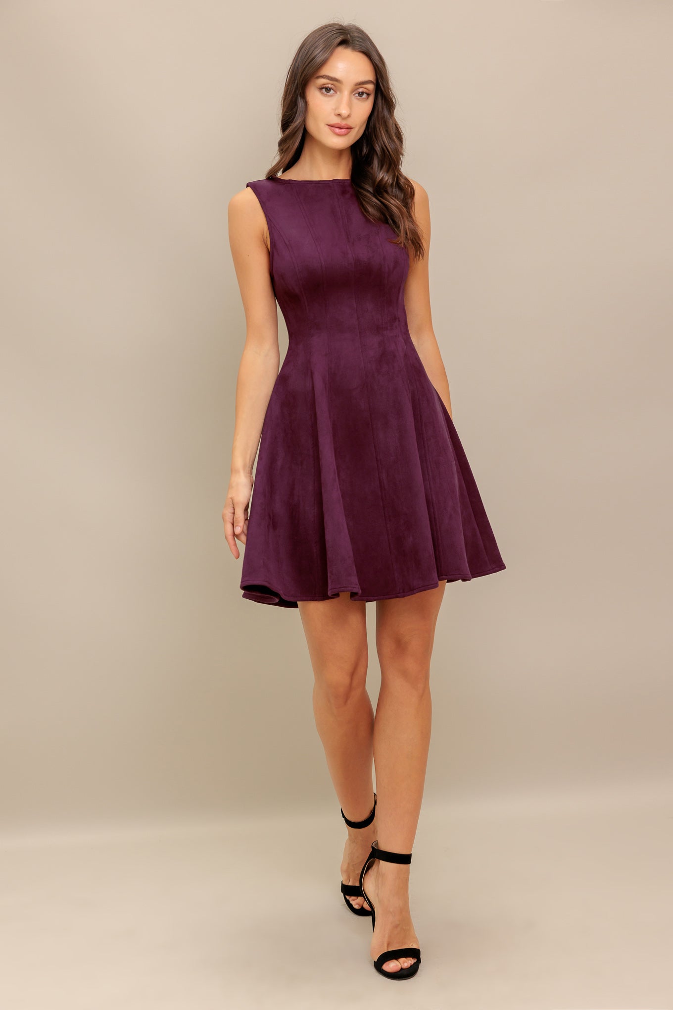 A solid faux suede mini dress featuring round neckline, sleeveless, circle skirt and back zipper closure
