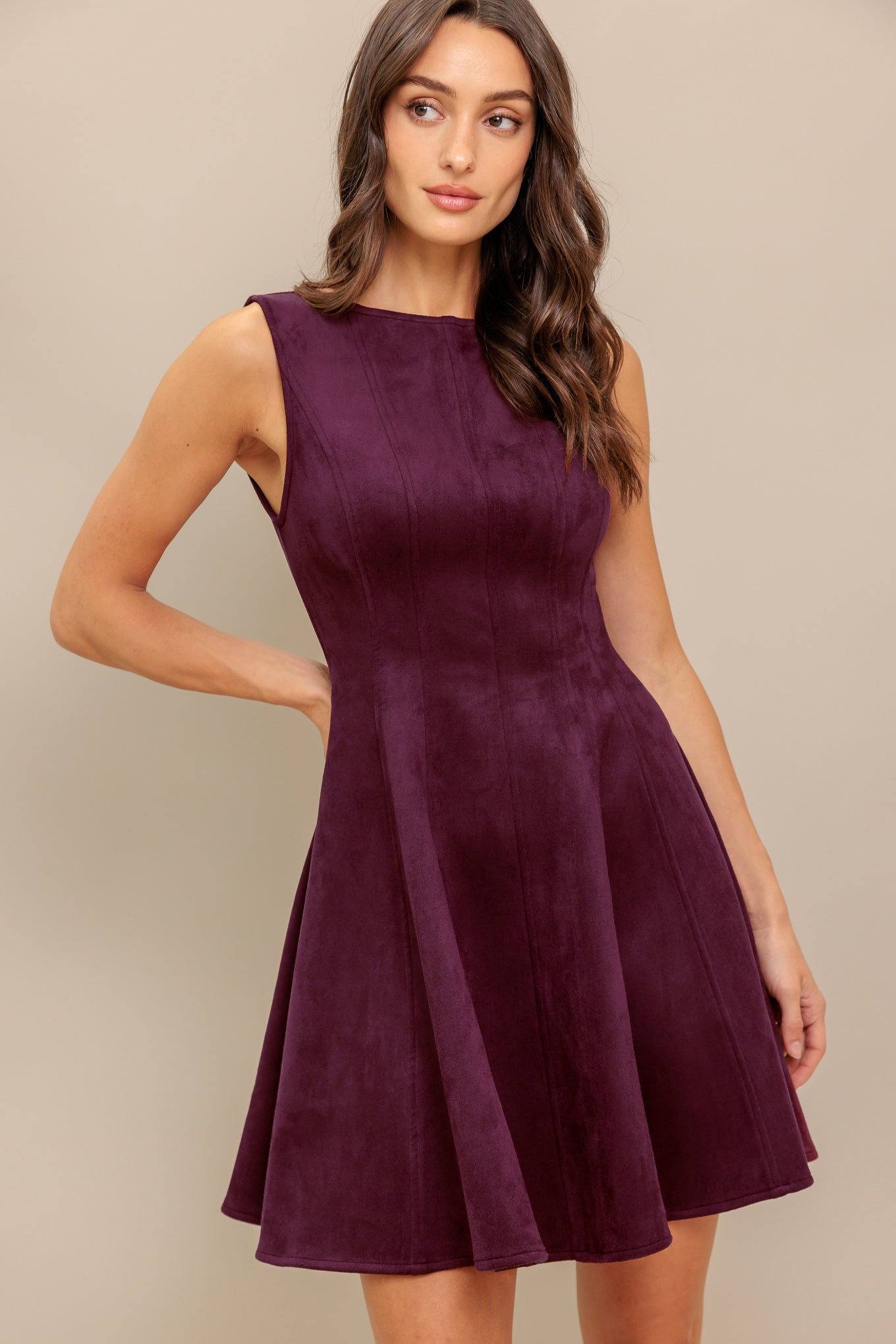 A solid faux suede mini dress featuring round neckline, sleeveless, circle skirt and back zipper closure