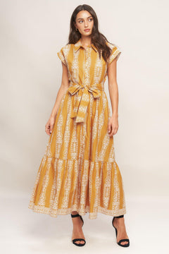 A printed woven midi dress featuring collar, button down, short sleeve, self sash tie and ruffled hemline