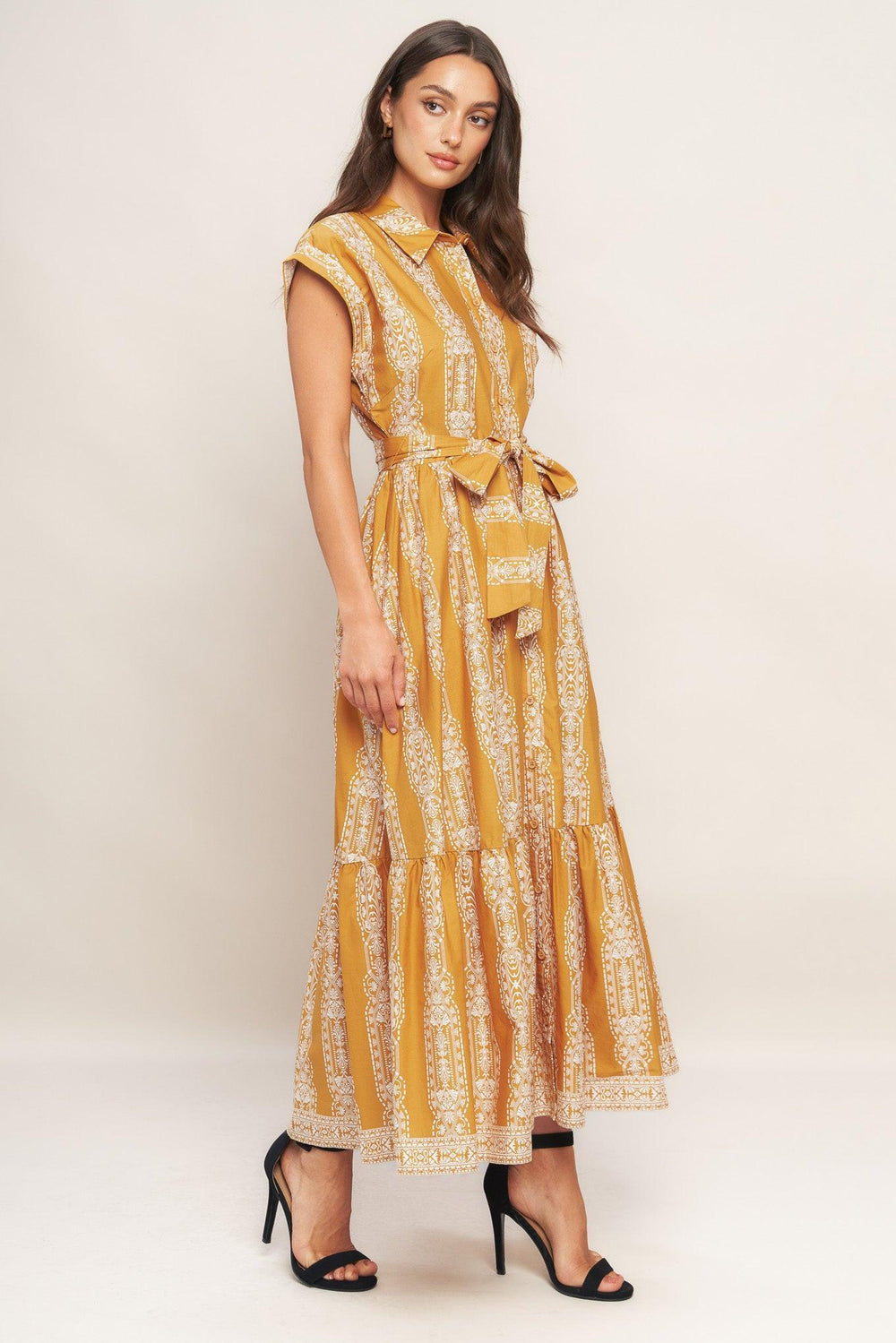 A printed woven midi dress featuring collar, button down, short sleeve, self sash tie and ruffled hemline