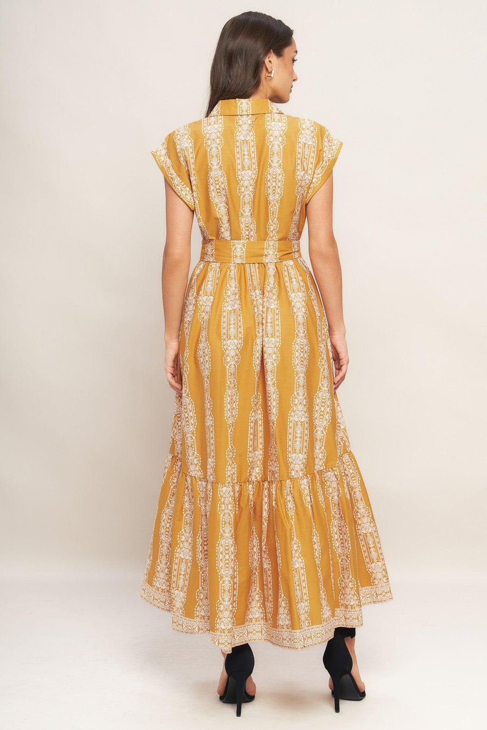 A printed woven midi dress featuring collar, button down, short sleeve, self sash tie and ruffled hemline