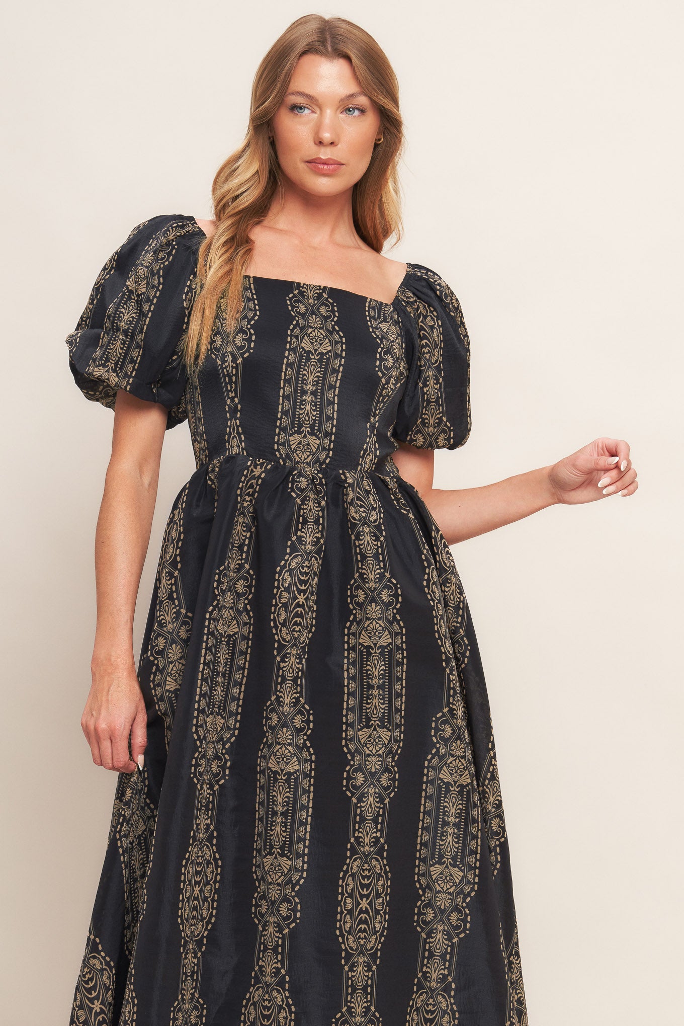 A printed woven midi dress featuring square neckline, short puff sleeve, full skirt and back zipper closure