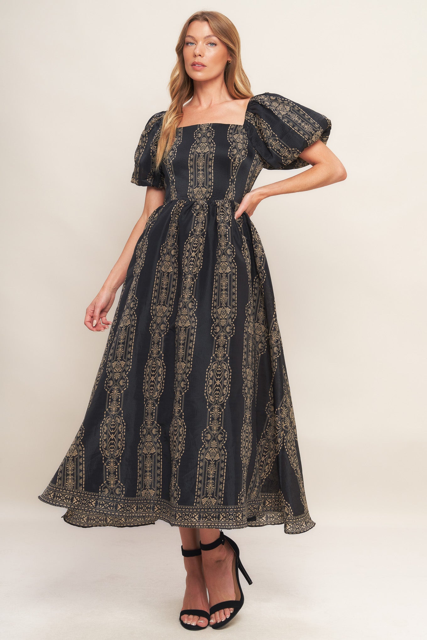 A printed woven midi dress featuring square neckline, short puff sleeve, full skirt and back zipper closure