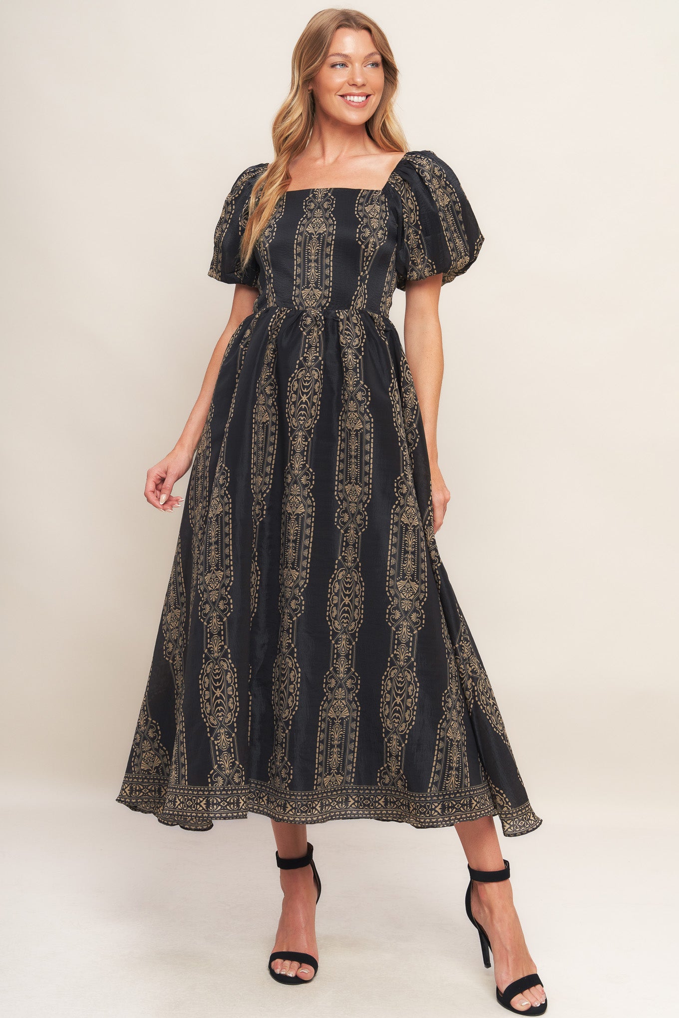 A printed woven midi dress featuring square neckline, short puff sleeve, full skirt and back zipper closure