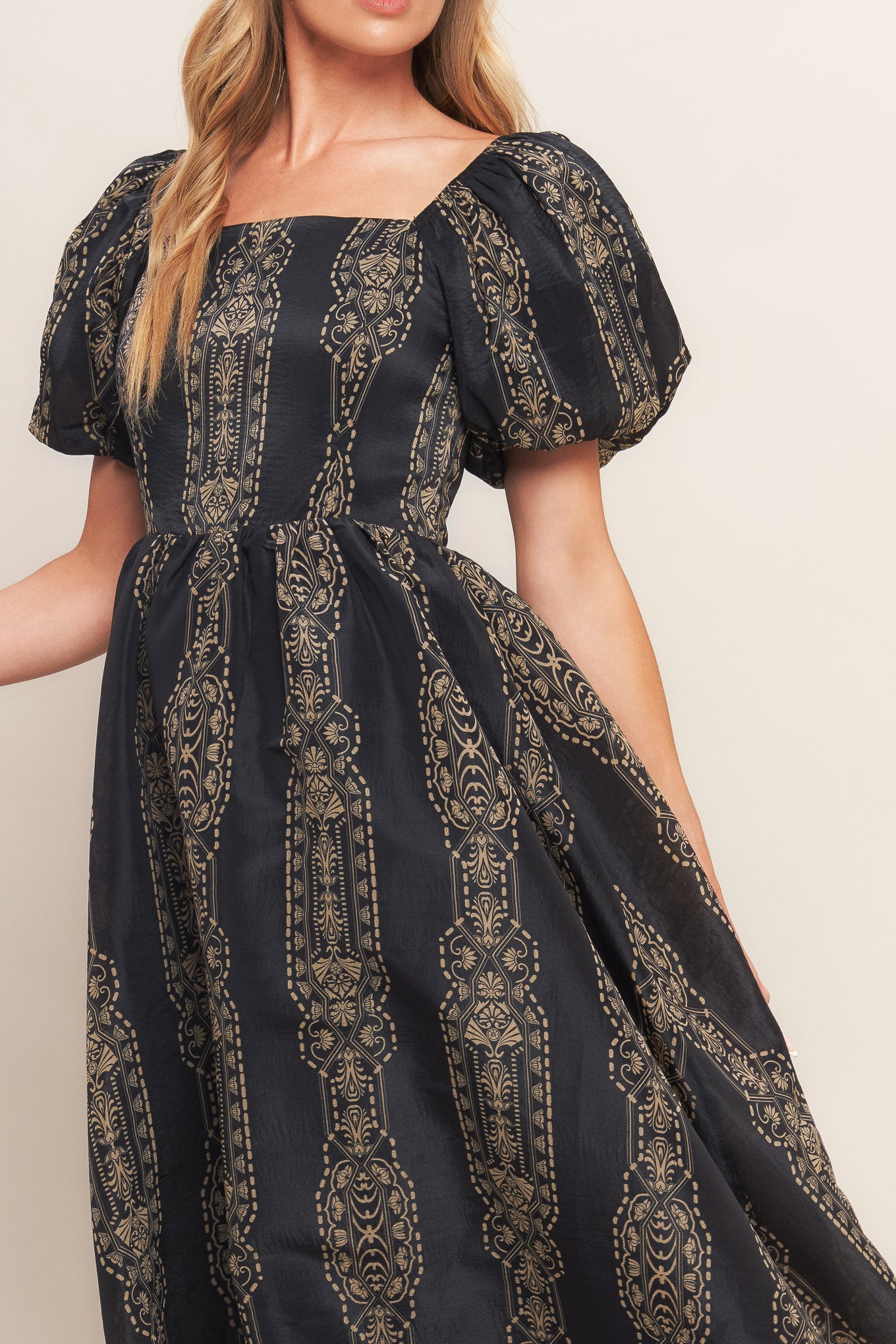 A printed woven midi dress featuring square neckline, short puff sleeve, full skirt and back zipper closure