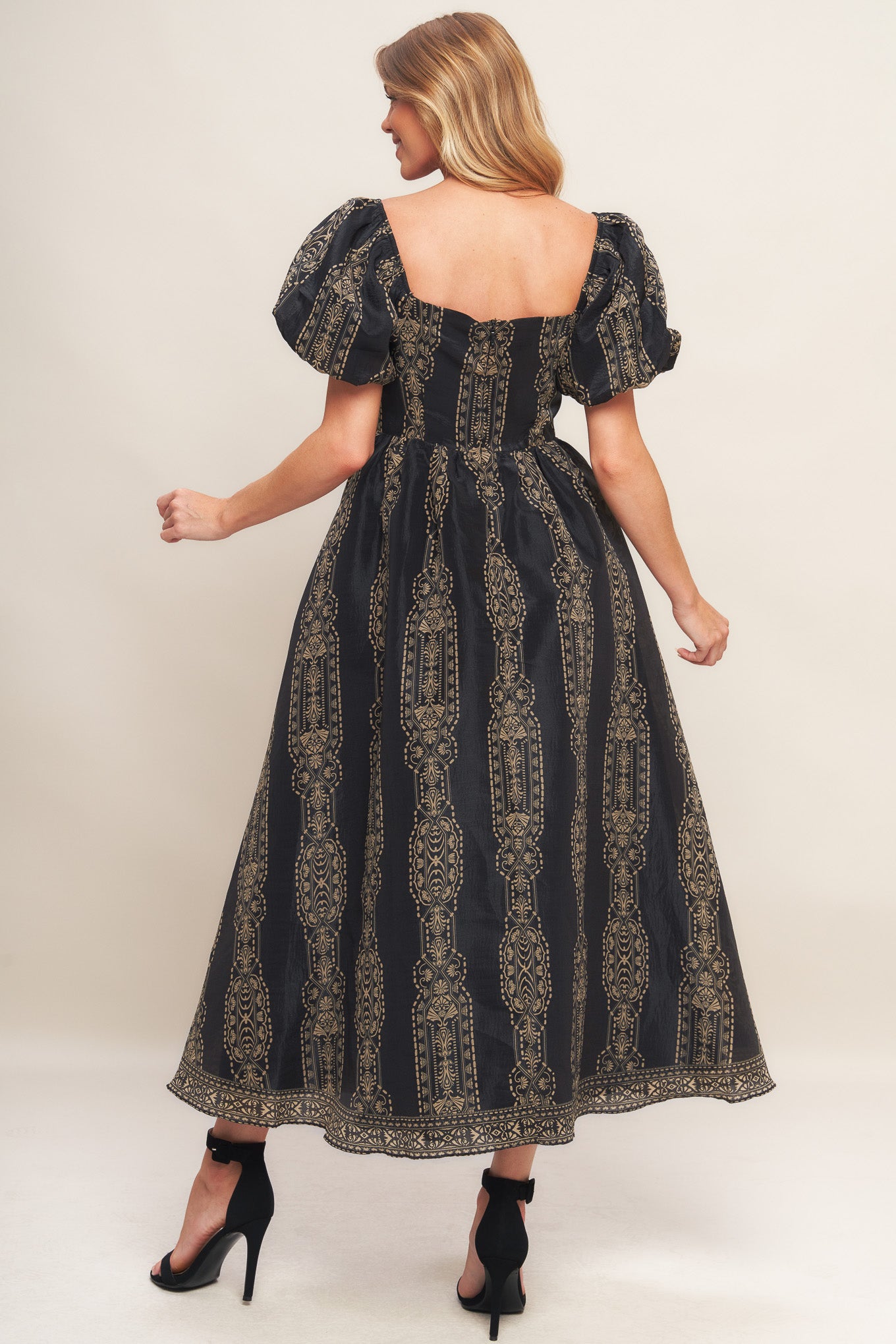 A printed woven midi dress featuring square neckline, short puff sleeve, full skirt and back zipper closure