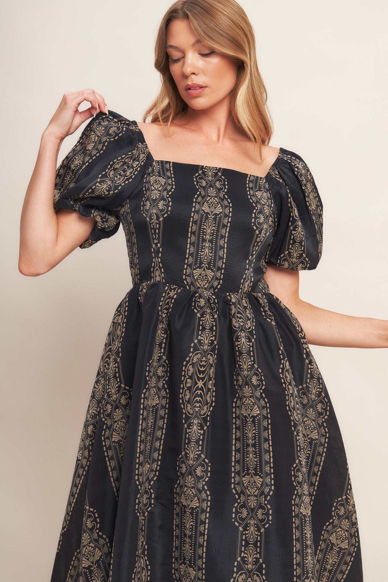 A printed woven midi dress featuring square neckline, short puff sleeve, full skirt and back zipper closure