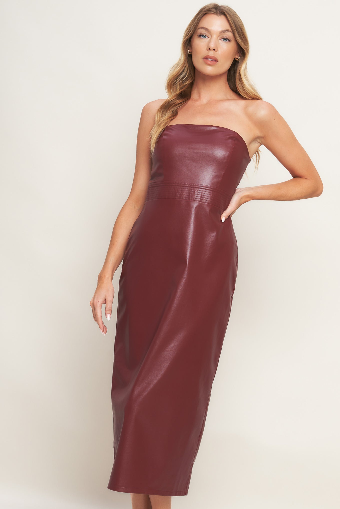 A faux leather midi dress featuring wide neckline, sleeveless, pencil skirt, back slit and back zipper closure