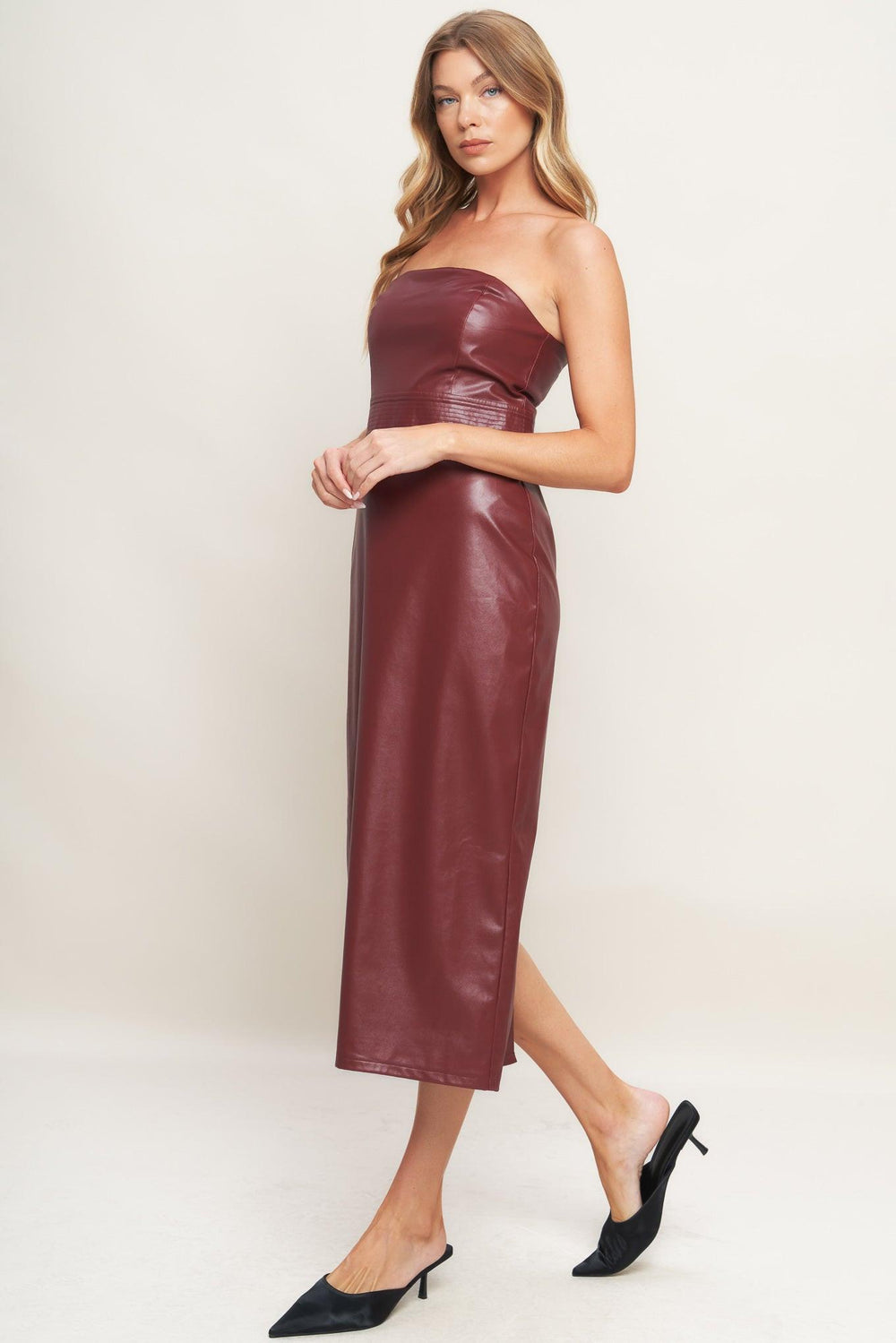 A faux leather midi dress featuring wide neckline, sleeveless, pencil skirt, back slit and back zipper closure