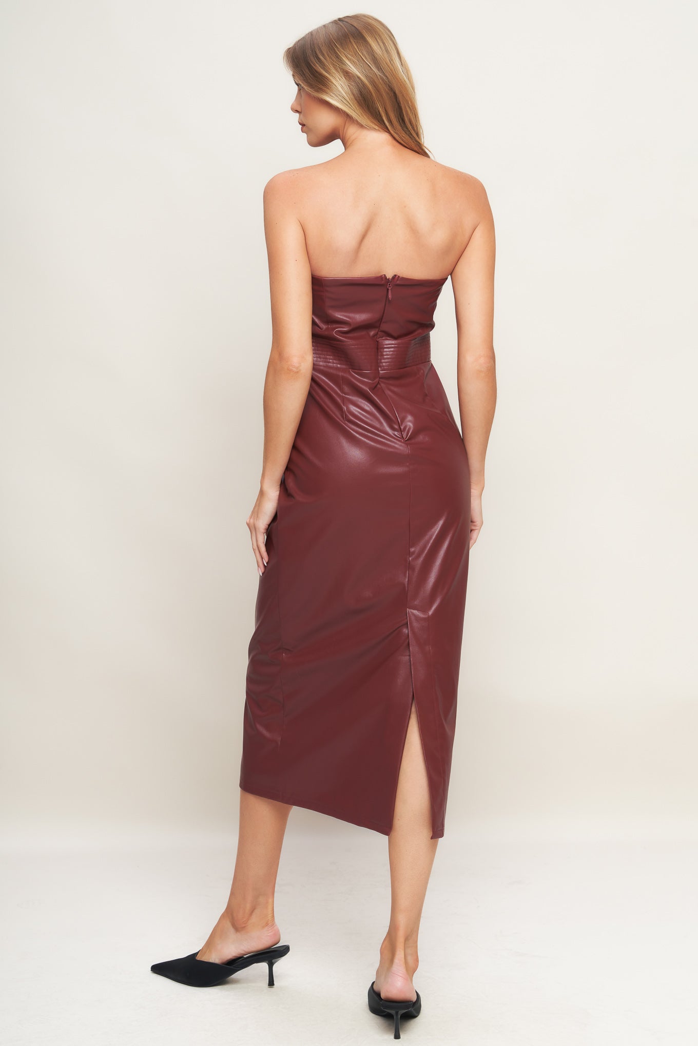 A faux leather midi dress featuring wide neckline, sleeveless, pencil skirt, back slit and back zipper closure