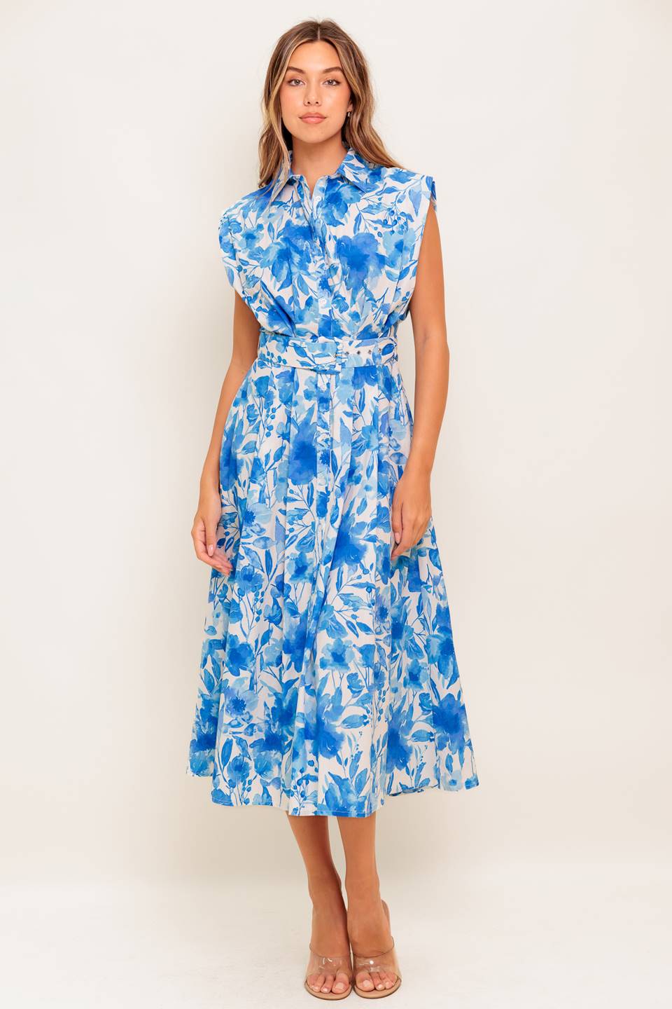 A printed woven midi dress featuring collar, short sleeve, button down, self belt and full skirt