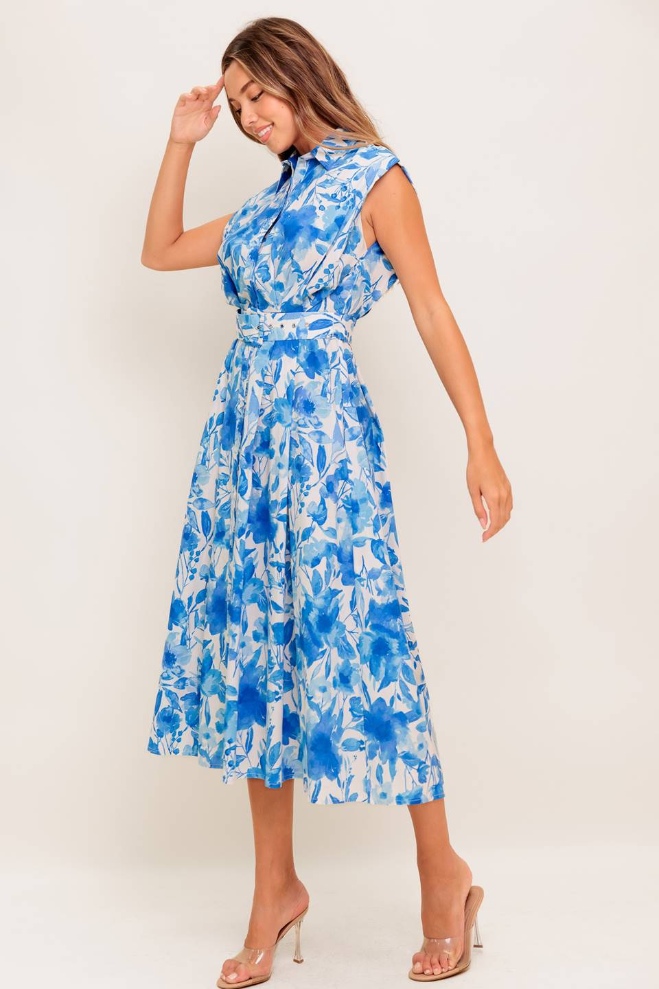 A printed woven midi dress featuring collar, short sleeve, button down, self belt and full skirt