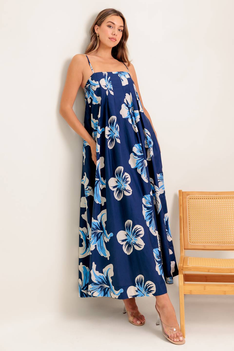 A printed woven maxi dress featuring straight neckline, straps and back zipper closure