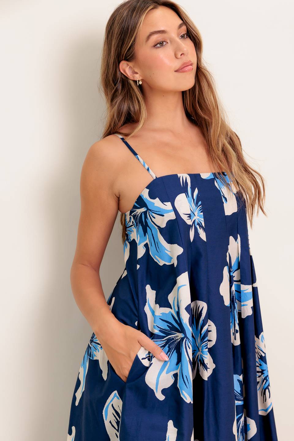 A printed woven maxi dress featuring straight neckline, straps and back zipper closure