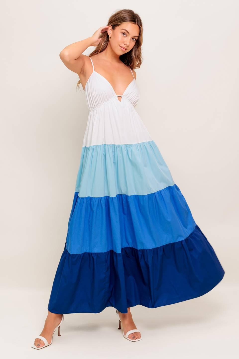 A color blocked woven maxi dress featuring cami top with straps, tiered skirt and back tie closure