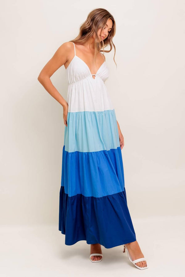 A color blocked woven maxi dress featuring cami top with straps, tiered skirt and back tie closure