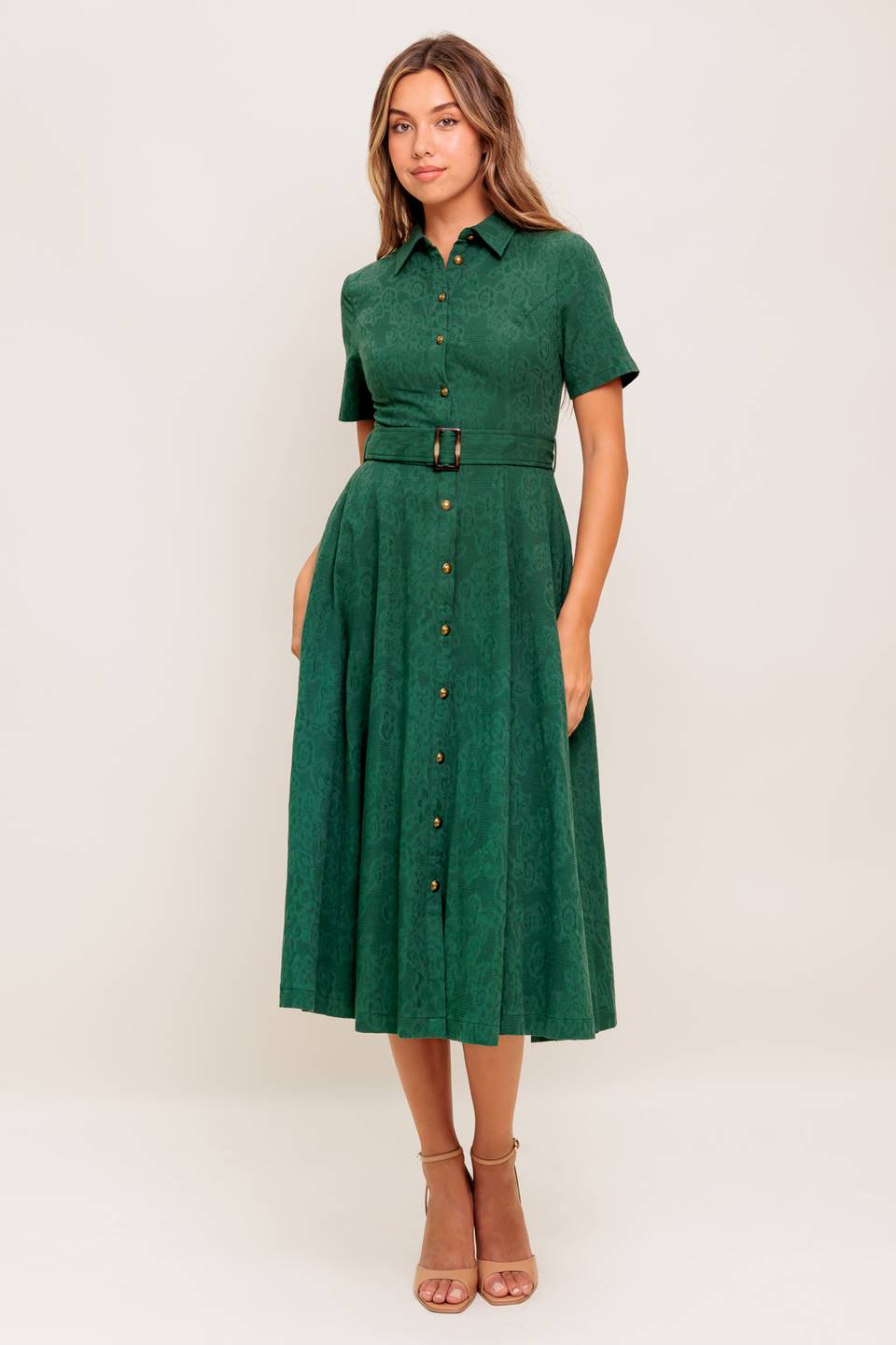 A jacquard woven midi dress featuring collar, short sleeve, button down, self belt, side pocket and full skirt
