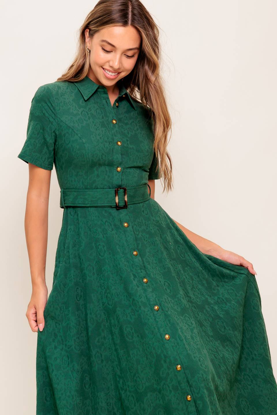 A jacquard woven midi dress featuring collar, short sleeve, button down, self belt, side pocket and full skirt