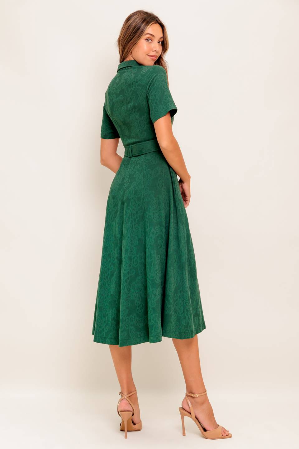 A jacquard woven midi dress featuring collar, short sleeve, button down, self belt, side pocket and full skirt