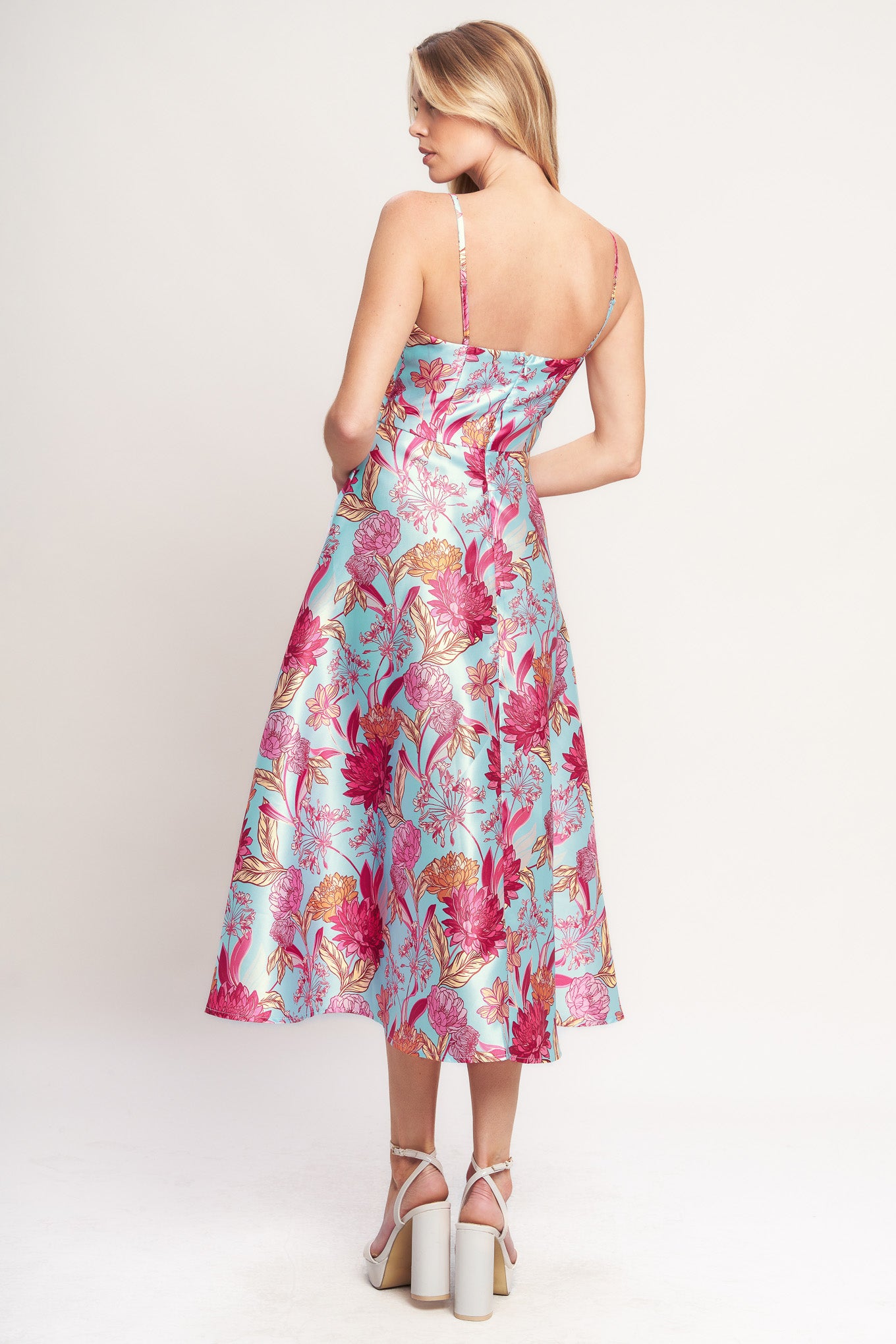 A printed woven midi dress featuring surplice neckline, straps, circle skirt and back zipper closure

Details:

Self: 100% Polyester
Lining: 100% Polyester

Size & Fit

- Model is 5`8" And Wearing Size Small
- Measurements Taken From Size Small
- Approx. Length: 49"