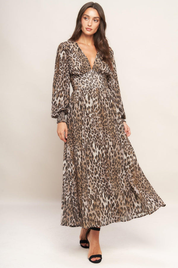 A printed woven midi dress featuring V neckline, long sleeve with smocked cuff, waist yoke and smocked back waist band