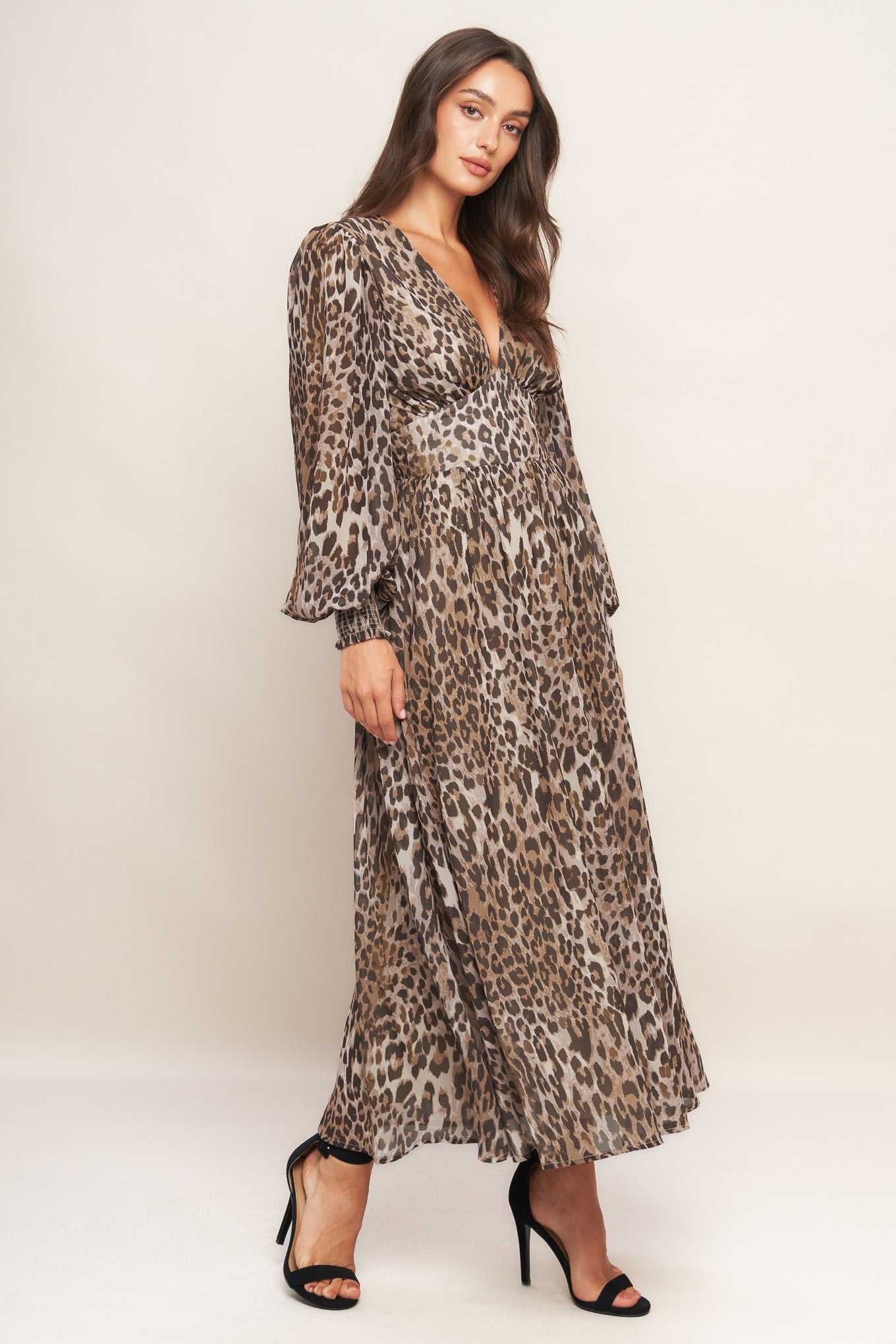 A printed woven midi dress featuring V neckline, long sleeve with smocked cuff, waist yoke and smocked back waist band