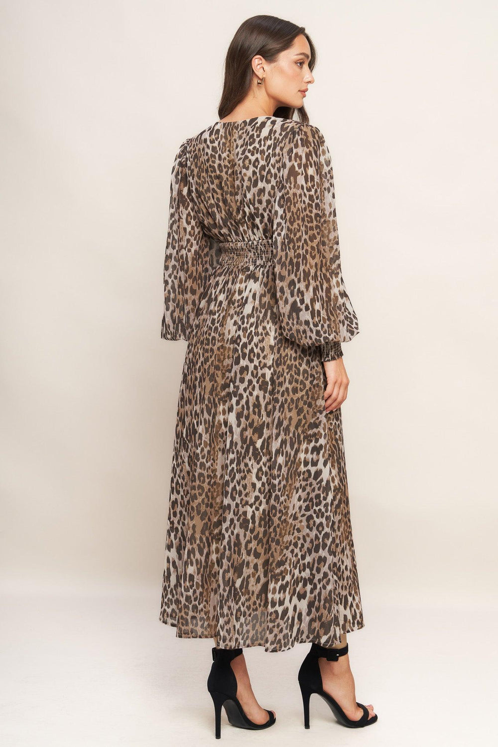 A printed woven midi dress featuring V neckline, long sleeve with smocked cuff, waist yoke and smocked back waist band