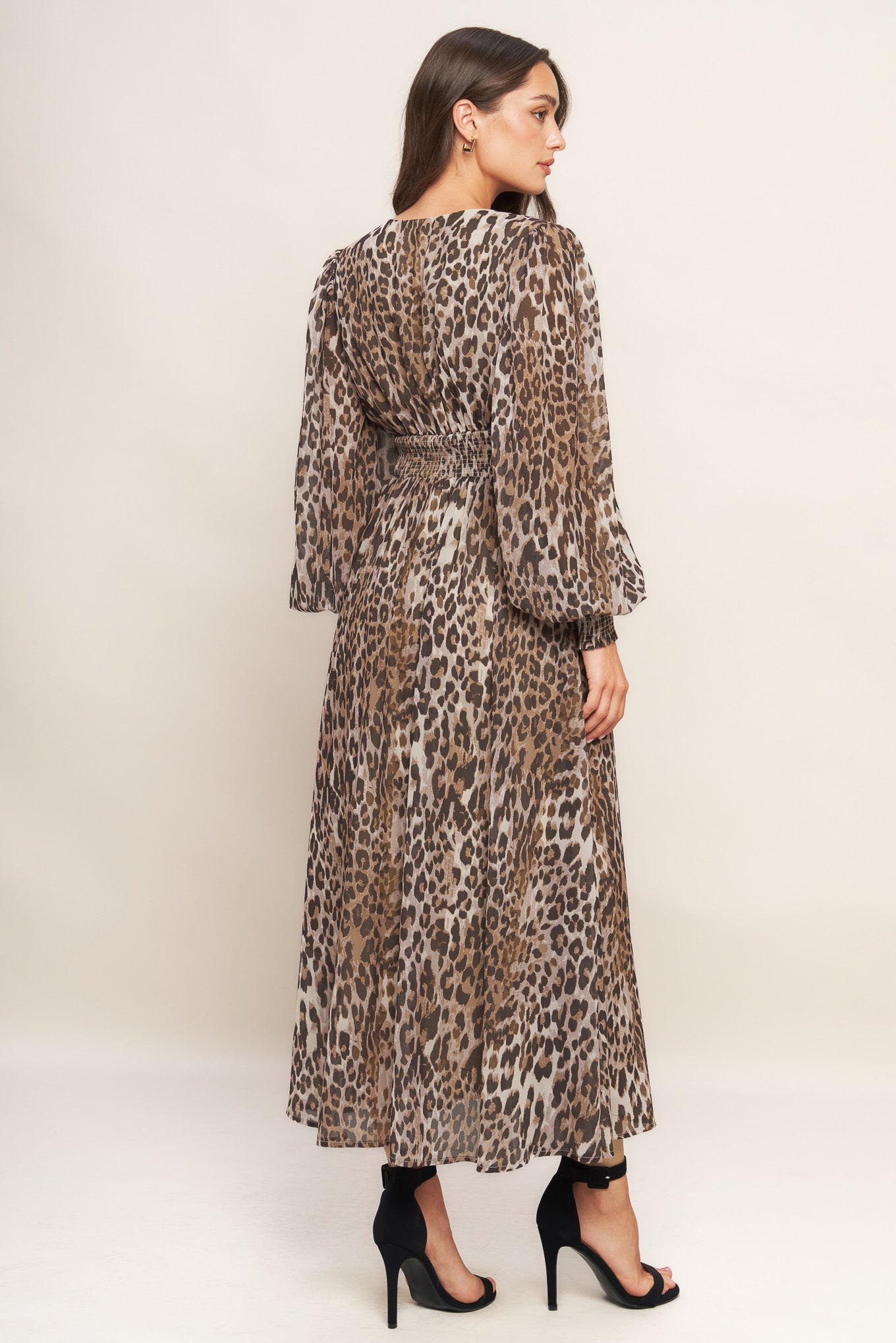 A printed woven midi dress featuring V neckline, long sleeve with smocked cuff, waist yoke and smocked back waist band