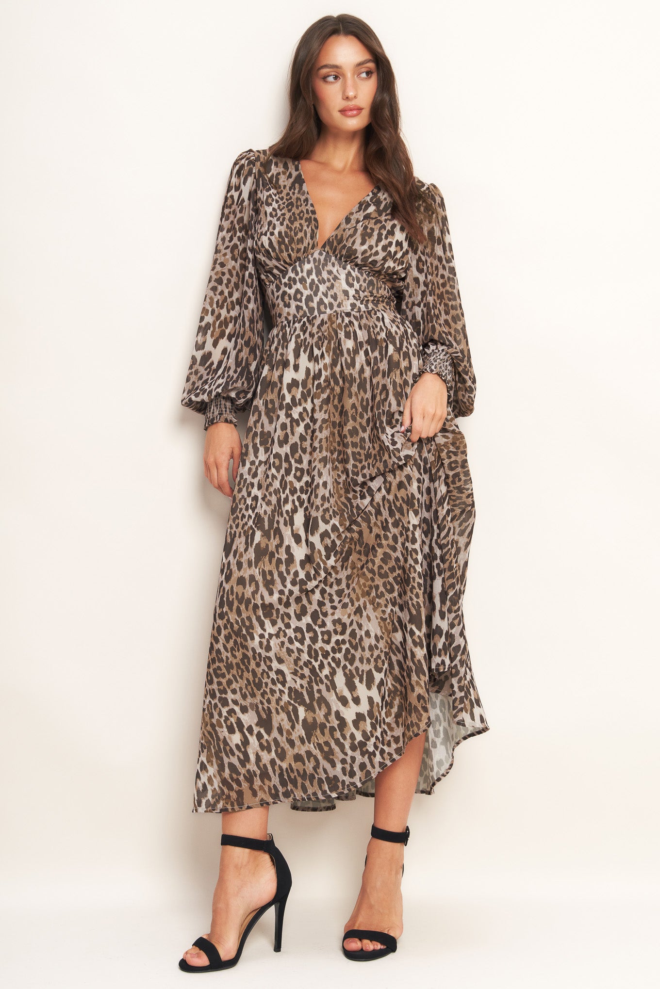 A printed woven midi dress featuring V neckline, long sleeve with smocked cuff, waist yoke and smocked back waist band