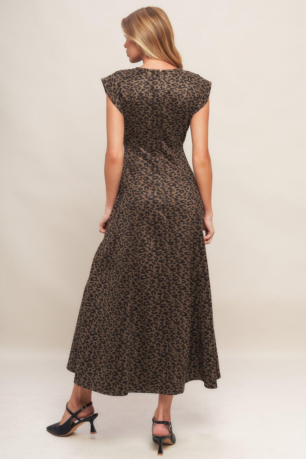 A printed sueded knit midi dress featuring round neckline, cap sleeve, circle skirt and back zipper closure