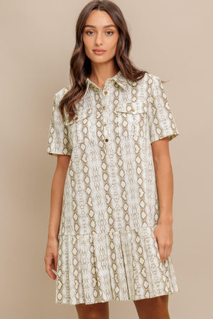 A printed woven mini dress featuring collar, short sleeve, pocket, button down and pleated bottom