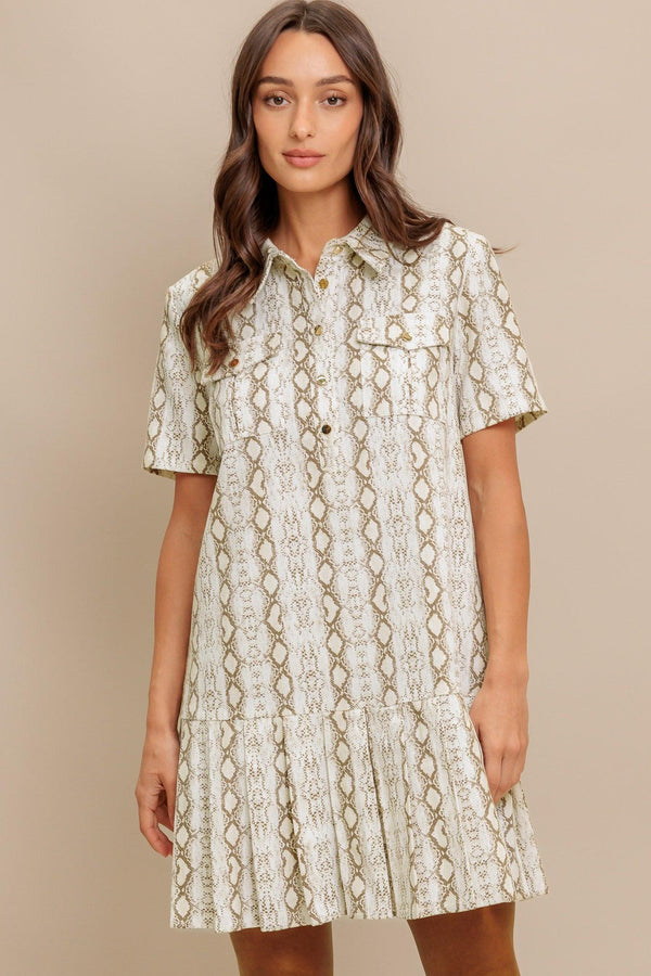 A printed woven mini dress featuring collar, short sleeve, pocket, button down and pleated bottom