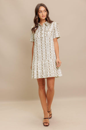A printed woven mini dress featuring collar, short sleeve, pocket, button down and pleated bottom