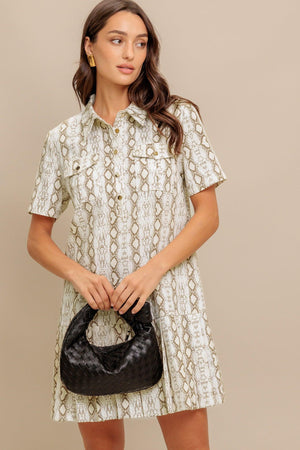 A printed woven mini dress featuring collar, short sleeve, pocket, button down and pleated bottom