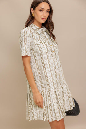 A printed woven mini dress featuring collar, short sleeve, pocket, button down and pleated bottom