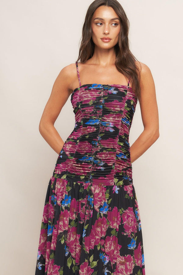 A printed power mesh maxi dress featuring straight neckline, straps, side shirring and back zipper closure