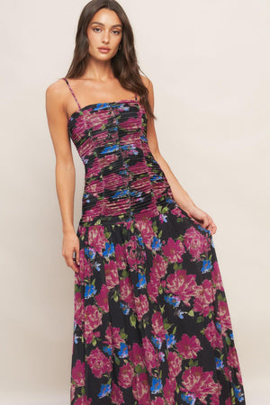 A printed power mesh maxi dress featuring straight neckline, straps, side shirring and back zipper closure