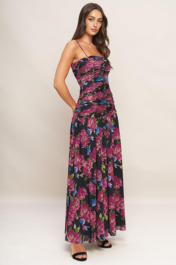 A printed power mesh maxi dress featuring straight neckline, straps, side shirring and back zipper closure