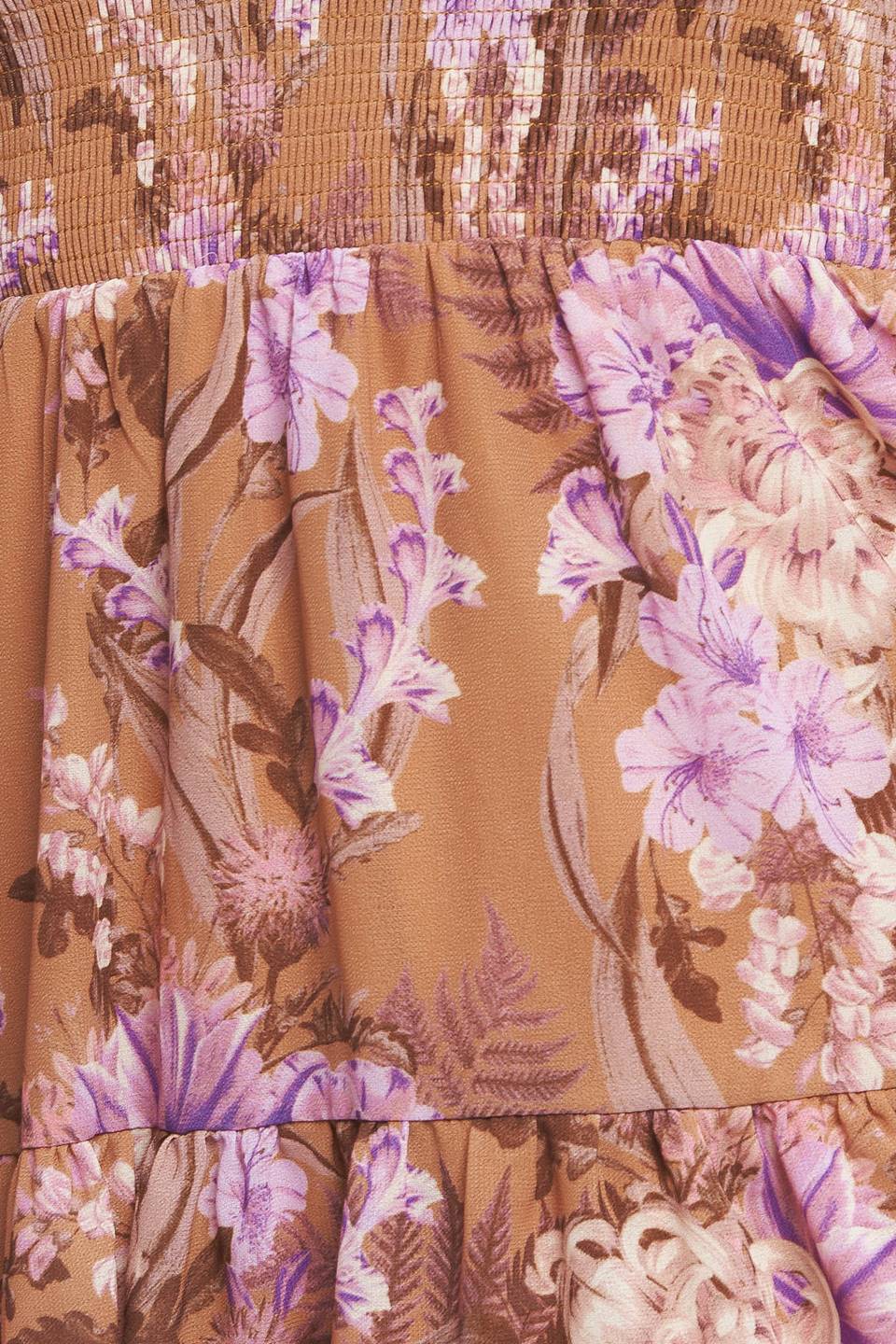 A printed woven mini dress featuring sweetheart neckline, smocked bodice, long sleeve with ruffled cuff and tiered skirt