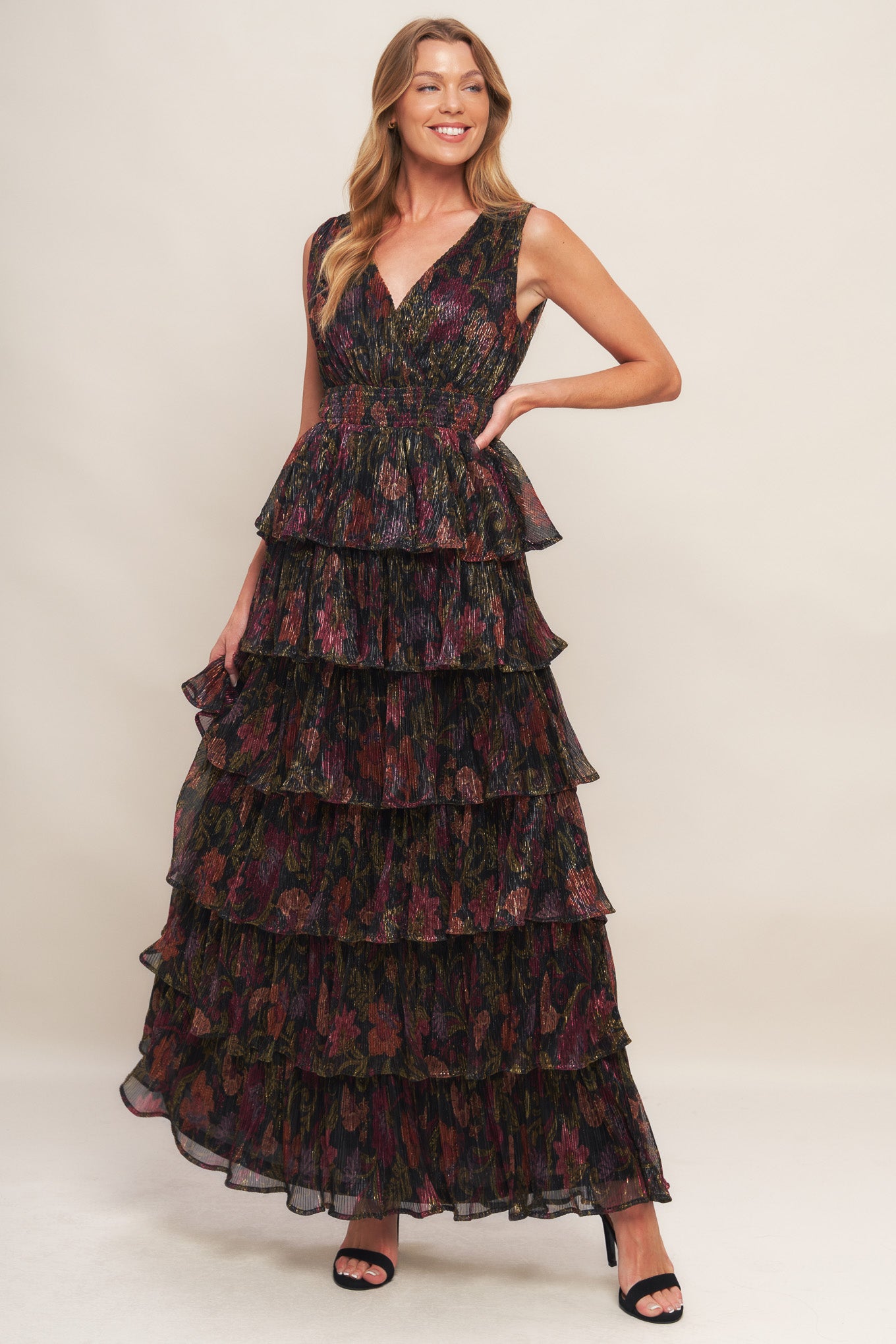 A woven micro-pleated maxi dress featuring surplice neckline, sleeveless, smocked waistband and layered skirt
