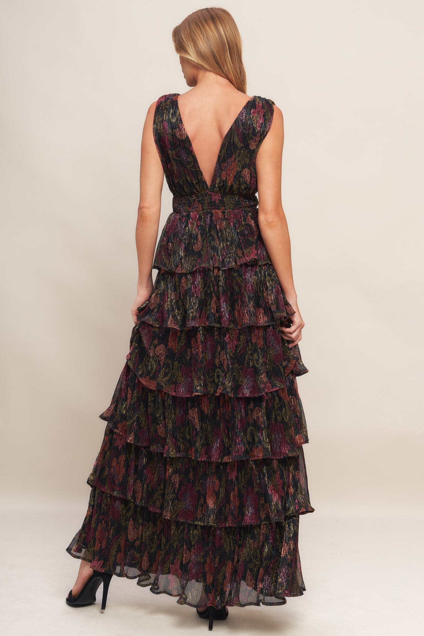 A woven micro-pleated maxi dress featuring surplice neckline, sleeveless, smocked waistband and layered skirt
